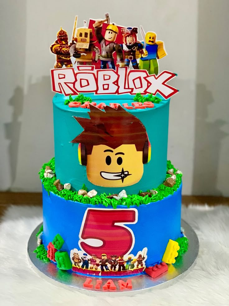 a lego movie themed birthday cake on a white furnishing area with the number 5