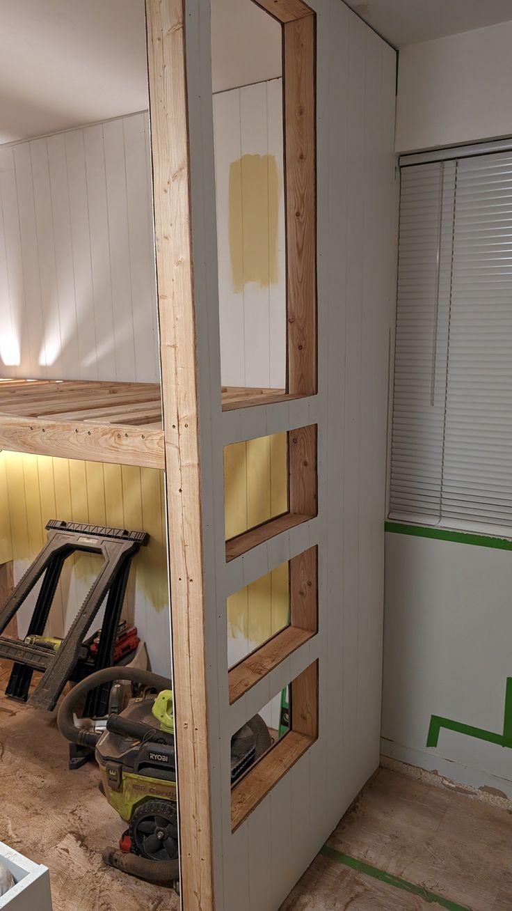 the interior of a house being remodeled with wood framing and paint on the walls, along with construction tools