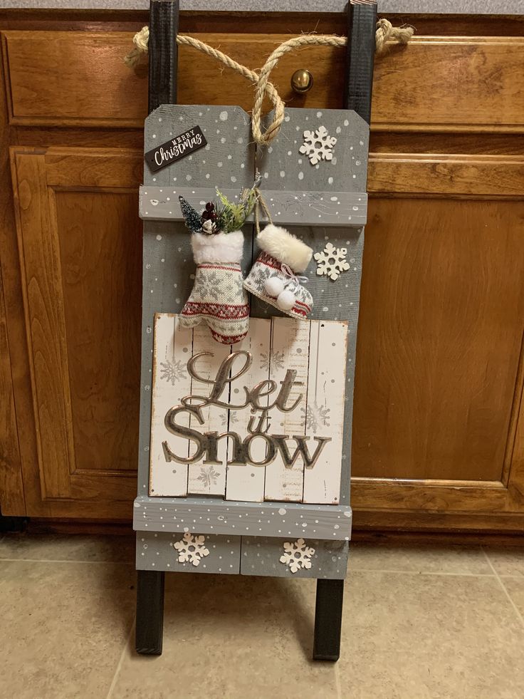 a wooden sign that says let it snow