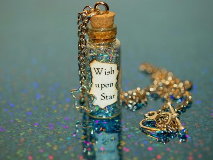 a wish upon star bottle necklace and keychain on a blue background with glitter