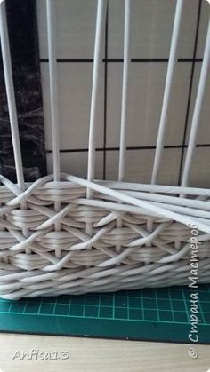 a white basket sitting on top of a green cutting board