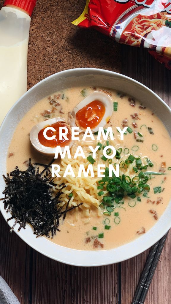 creamy mayo ramen in a white bowl with chopsticks and condiments