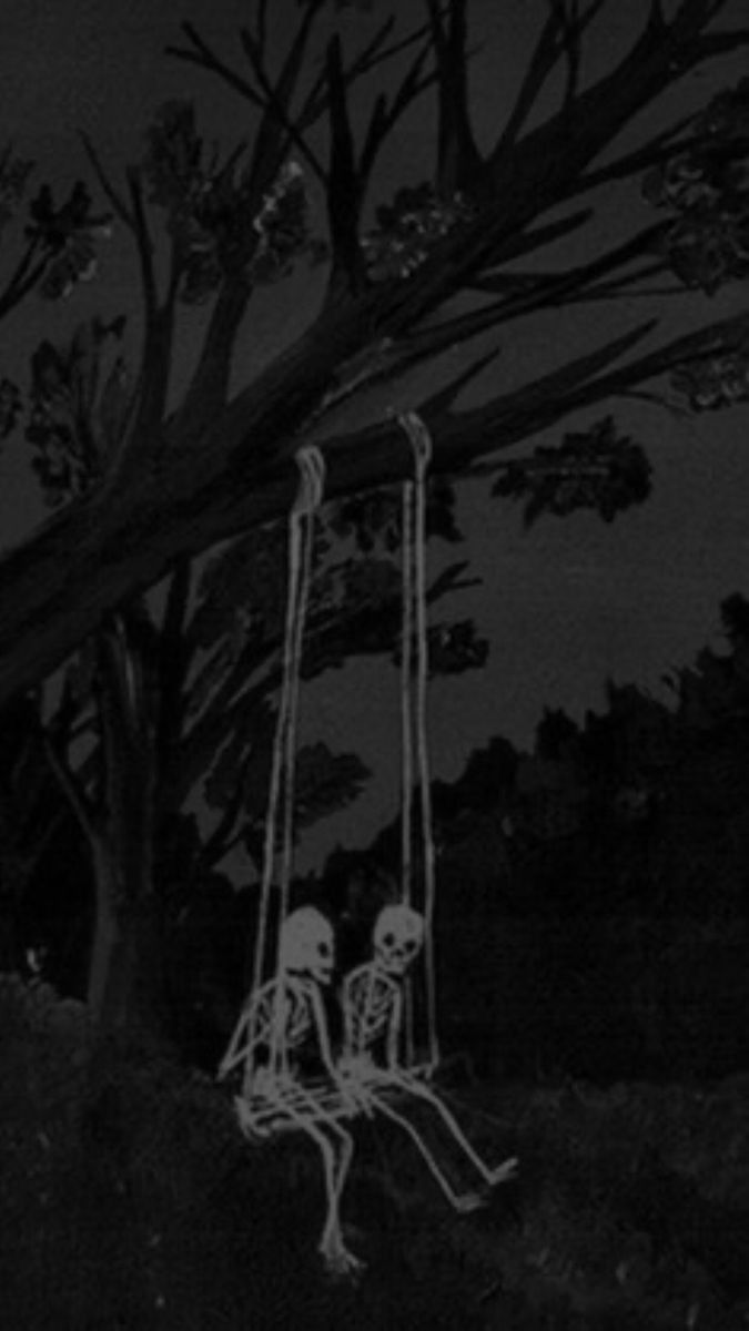 two skeletons sitting on swings in the dark