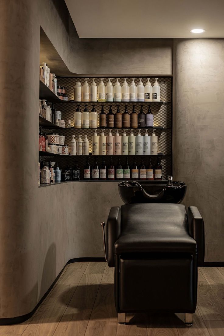 a hair salon with lots of bottles on the wall and chairs in front of it