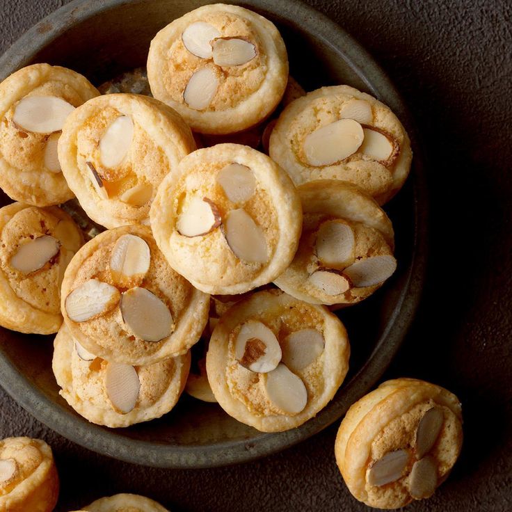 a bowl filled with cookies and almonds on top of a table