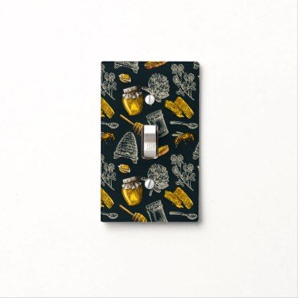 a black and yellow light switch cover with different items on it