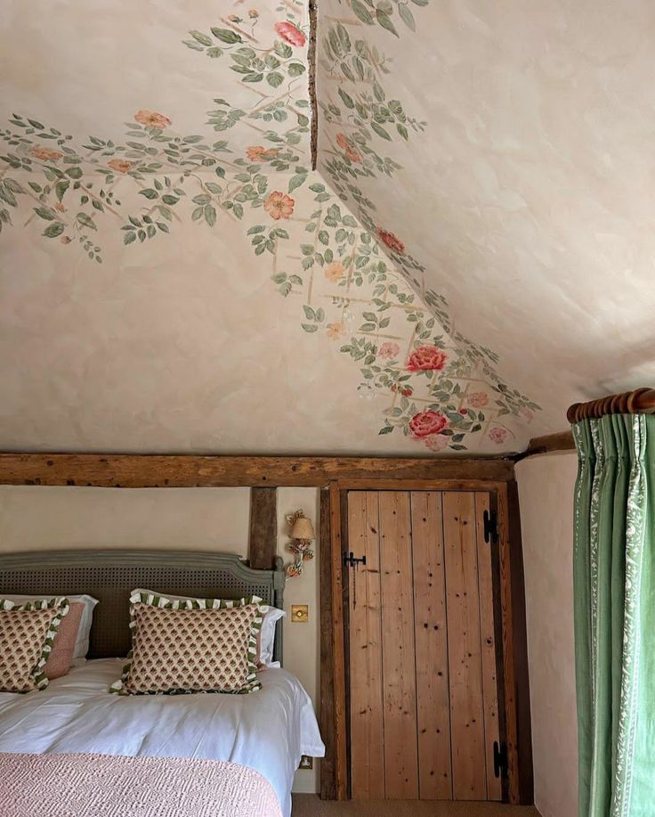 a bed sitting under a painted ceiling in a bedroom