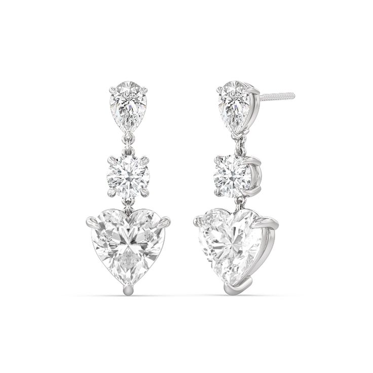 Perfect for any special day, this pair of diamond earrings is sure to give your look a dazzling finish. Each dangling earring features a trio of diamonds in pear, round, and heart shapes; together, they reflect light in an extra brilliant way. Classic Brilliant Cut Chandelier Earrings For Anniversary, Elegant Formal Heart Earrings With Prong Setting, Classic Pear-shaped Chandelier Earrings For Anniversary, Elegant Formal Heart Earrings, Elegant Diamond White Heart Earrings With Prong Setting, Three-stone Diamond Earrings For Anniversary, Elegant Round Cut Heart Earrings For Formal Occasions, Elegant Diamond Heart Earrings With Round Cut, Three-stone Diamond Earrings For Wedding