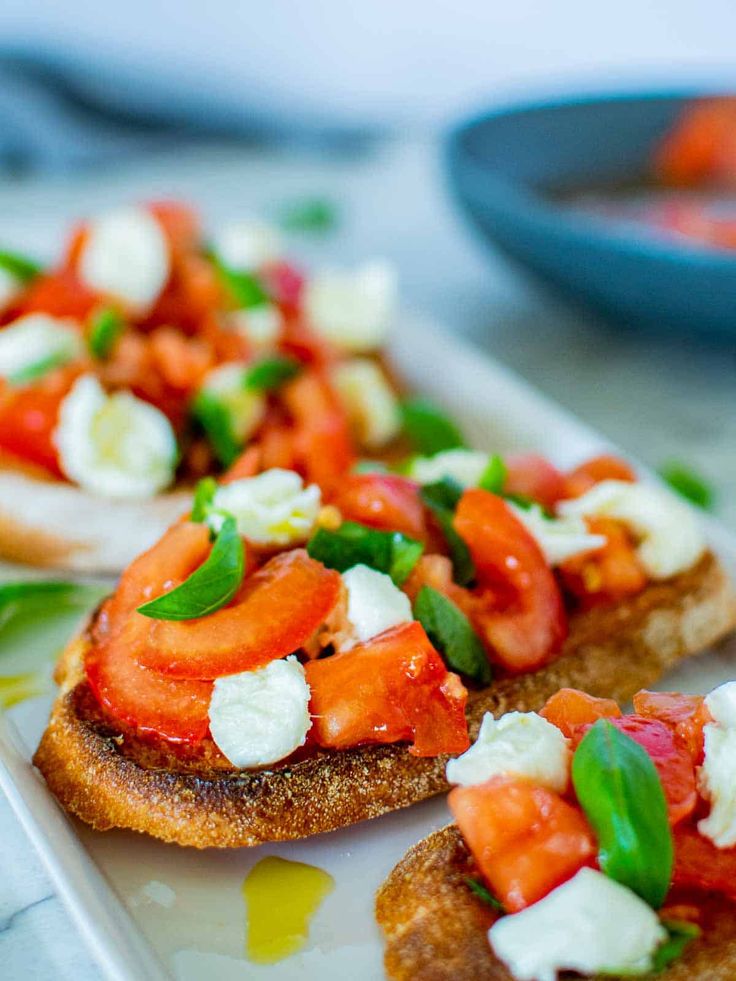 two pieces of bread topped with tomatoes and cheese