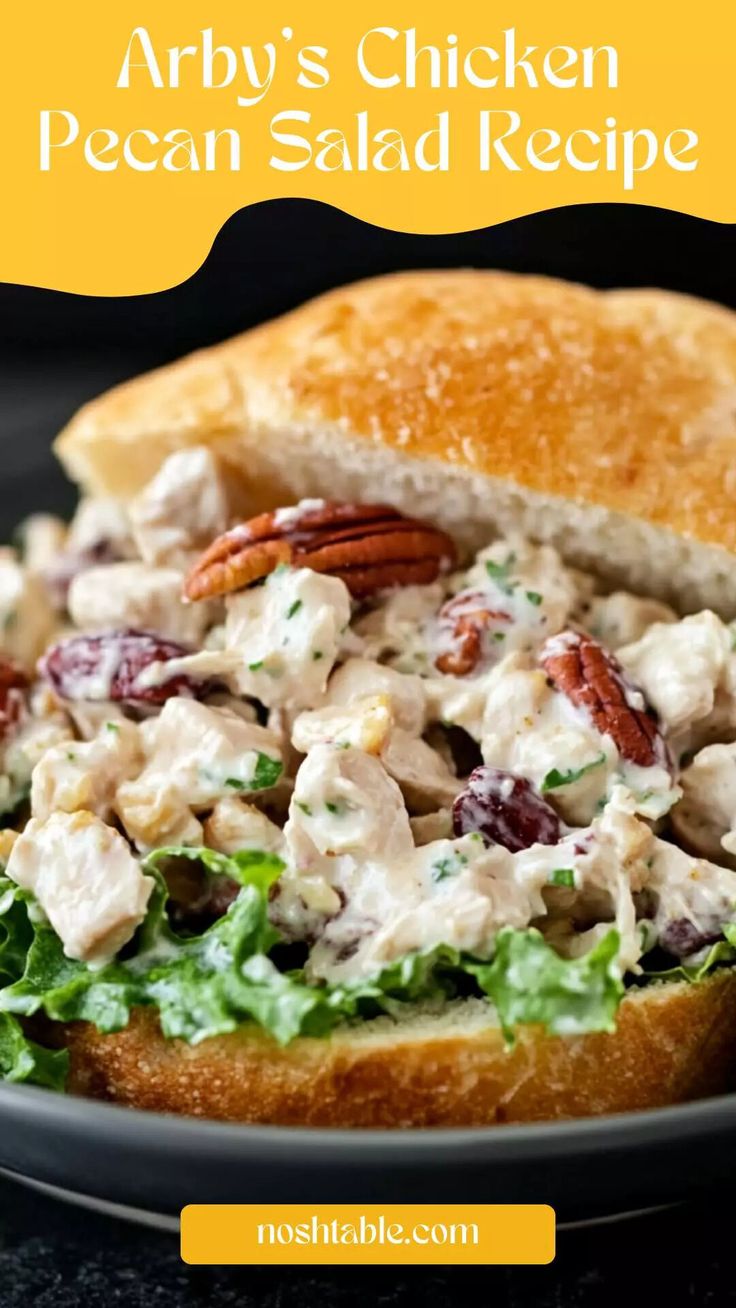 a chicken salad sandwich with pecans and cranberries in it on a plate