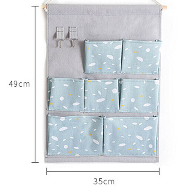 the hanging organizer is made from fabric and has four pockets for compartments to hold small items