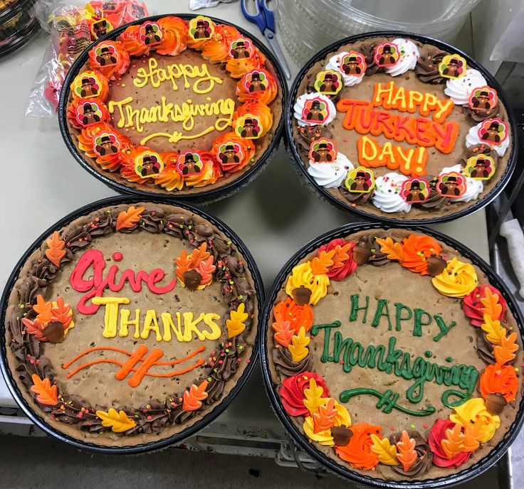 four decorated thanksgiving cakes sitting on top of a table