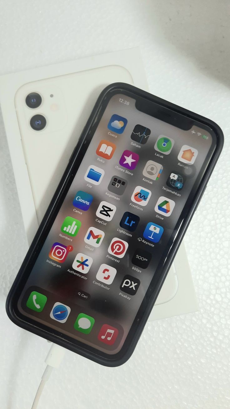 an iphone sitting on top of a white table