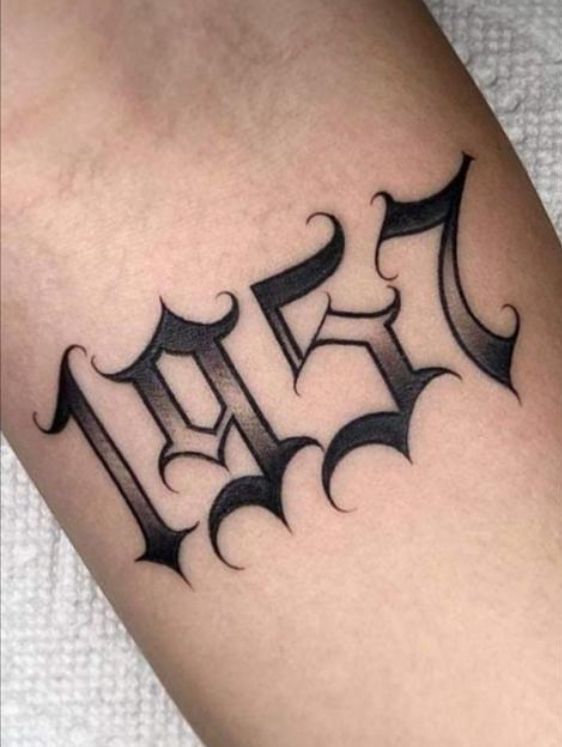 a black and white tattoo with the letter f on it's arm, in gothic style