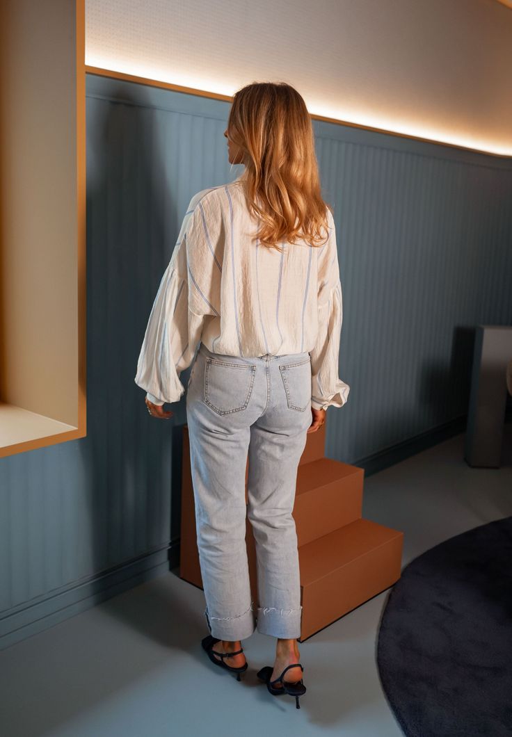 Pale-light yellow long sleeve collared shirt that features chic blue stripes while offering a flowy-comfortable fit. The perfect versatile and classy shirt that you can style up or down no matter the season or occasion. Our model also wears the Light Blue Maddie Jeans. Sizes: S-M / M-L S-M: Length 23.23 in - Width 22.44 in M-L: Length 24.41 in - Width 23.23 in 86% Rayon - 12% Polyester - 2% Nylon Washing: handwash only Spring Long Sleeve Blouse With Striped Collar, Spring Blouse With Striped Collar And Long Sleeves, Long Sleeve Blouse With Striped Collar For Day Out, Chic Blouse With Striped Collar For Day Out, Casual Long Sleeve Blouse With Striped Collar, Chic Long Sleeve Blouse With Striped Collar, Spring Oversized Blouse With Striped Collar, Oversized Blouse With Striped Collar For Spring, Spring Striped Relaxed Fit Blouse