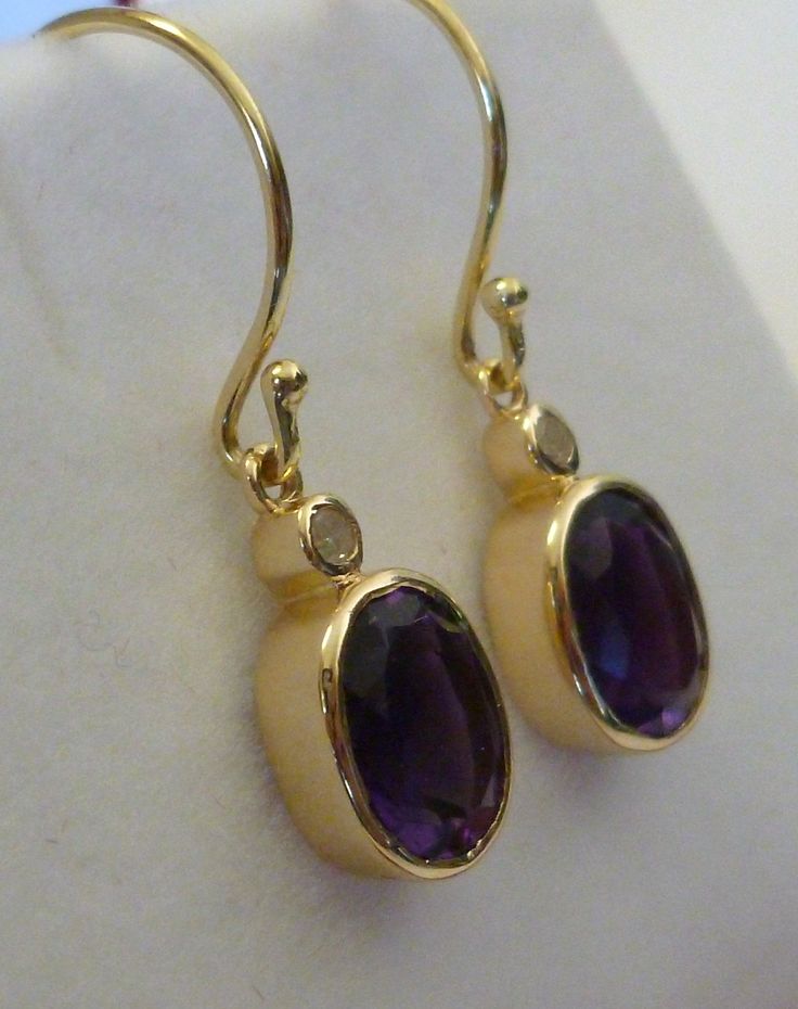 Are you looking for a simple yet elegant design that looks beautiful for the day or evening wear? These Amethyst and Diamond earrings have been handcrafted in 9ct/9k solid yellow gold with NATURAL Oval Cut Amethysts and GENUINE Diamonds. Attached are French Hook wires. We can also make these earrings in the choice of colour that you prefer such as rose gold or white gold. Hallmark Stamp: 9ct 9k 375 Solid Gold Natural GemStones: Amethysts (approx. 3.90ct total), Diamonds (Colour G, Clarity SI1, 0 14k Gold Bezel Set Drop Earrings, Elegant Teardrop Bezel Set Earrings, Classic Teardrop Bezel Set Earrings, Classic Teardrop Earrings With Bezel Setting, Modern Formal Earrings With Bezel Setting, Modern Bezel Set Earrings For Formal Occasions, Elegant Gold Earrings With Bezel Setting, Modern Oval Hallmarked Earrings, Formal Oval Earrings With Bezel Setting