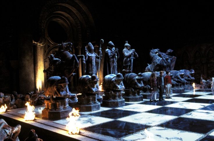 a large chess board with statues on it