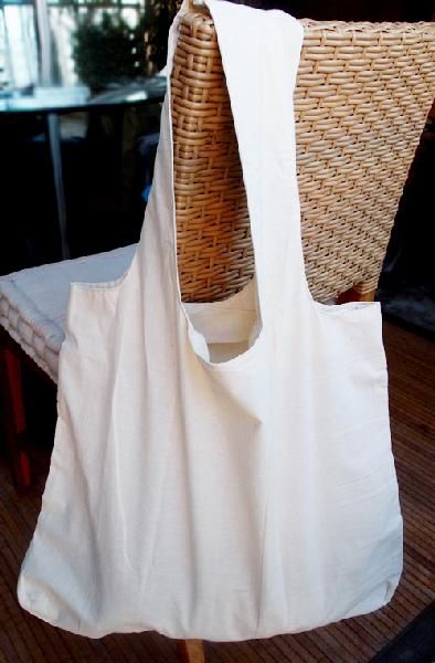 a wicker chair with a white bag on it