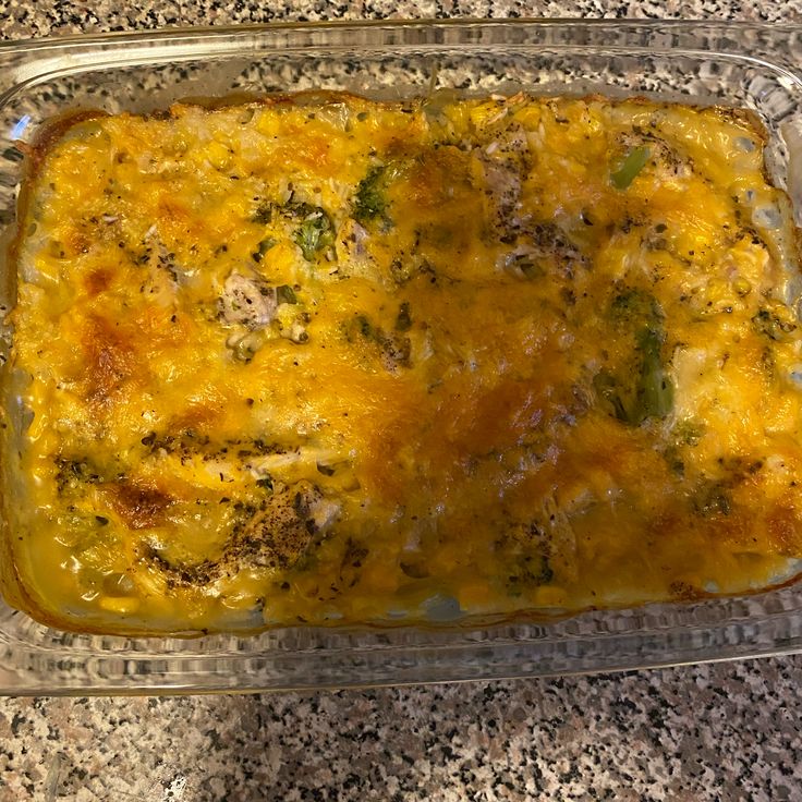 a casserole dish with cheese and broccoli in it on a counter