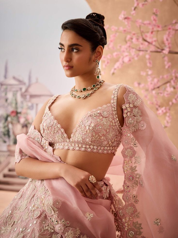 Embrace graceful elegance with this soft lilac lehenga, beautifully embellished with appliqué and stunning 3d floral details. Adorned with intricate cutdana, sequins, pearls, and stones, this lehenga exudes a refined charm, making it an enchanting choice for special occasions and celebrations. Lilac Lehenga, Onion Pink, Charm Making, Silk Organza, Indian Design, Every Woman, Lehenga, Pink Floral, Timeless Elegance