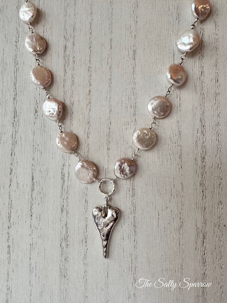 Coin pearls with the softest hint of blush hues, finished off with a silver heart pendant. Measures 16” Pearl Heart Necklace, Pearl Heart, Emerald Coast, Coin Pearls, Silver Heart Pendant, Silver Heart, Heart Necklace, Heart Pendant, Coin