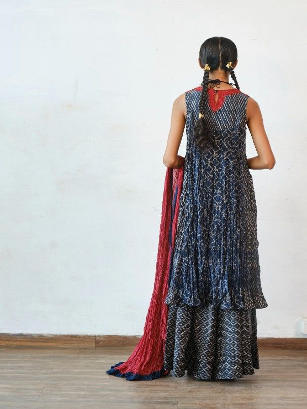 Crushed printed chanderi kurta with kathiawadi embroidered yoke paired with palazzo pants and crushed chanderi dupatta Color: Indigo Fabric: Chanderi Note: The product will be delivered within 3-4 weeks of order placed Wash care - Dry clean only The size can be cutomised Additional charges of 10% on MRP shall be charged for sizes - XL, 2XL, 3XL, 4XL, 4XL and 6XL Size Chart (In Inches): XS S M L XL 2XL 3XL Bust 32 34 36 38 40 42 44 Waist 25 26 28 30 32 34 34 Hips 35 37 39 41 43 45 47 Designer Bandhani Print Palazzo Set For Navratri, Designer Bandhani Print Anarkali Set In Georgette, Designer Georgette Anarkali Set With Bandhani Print, Festive Slub Silk Sets With Bandhani Print, Eid Bandhani Print Palazzo Set For Designer Wear, Traditional Drape Palazzo Set With Bandhani Print For Diwali, Eid Designer Palazzo Set With Bandhani Print, Designer Bandhani Print Sharara With Traditional Drape, Exclusive Bandhani Print Sharara In Traditional Drape