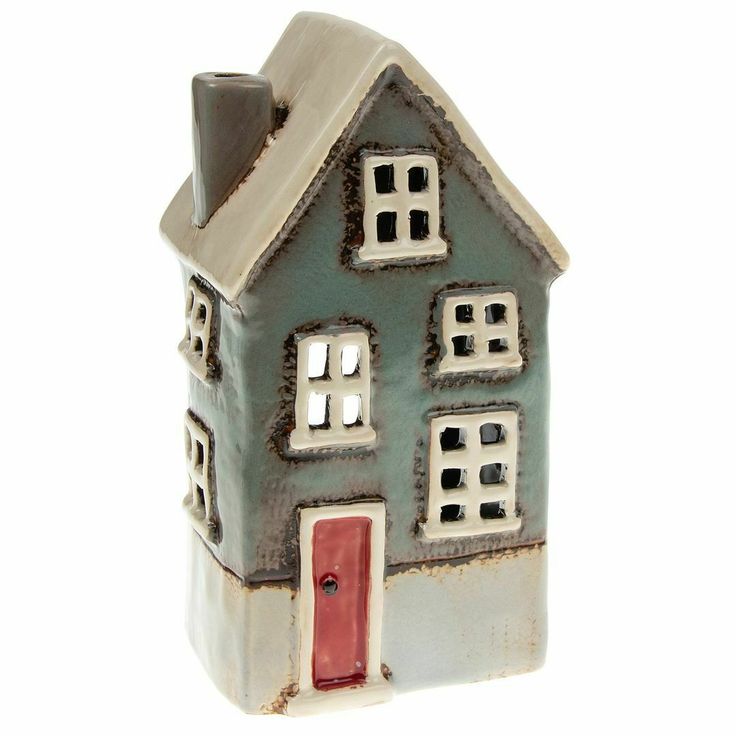 a small ceramic house is shown on a white background