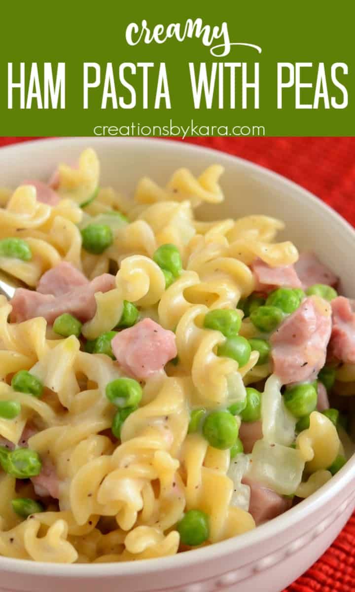 a bowl filled with pasta and peas on top of a red table cloth next to a spoon