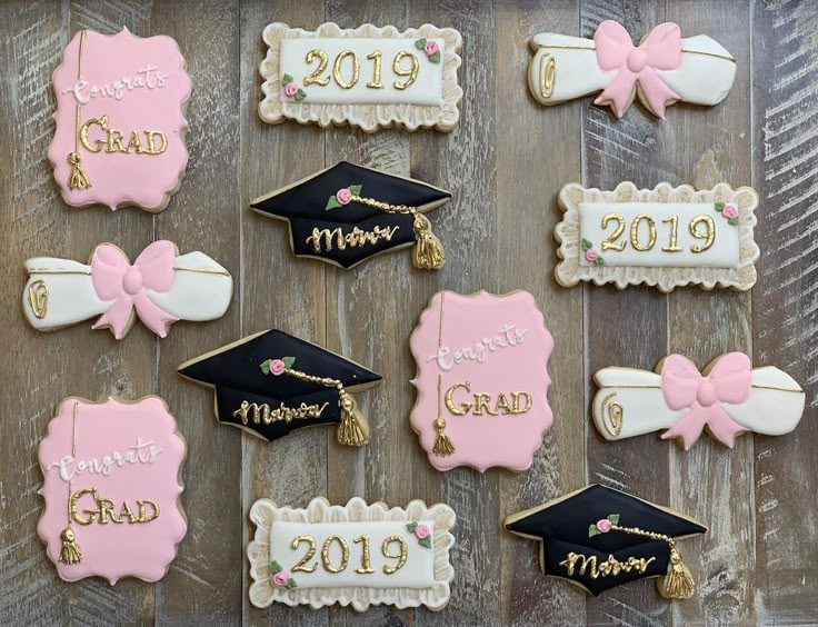 decorated cookies with graduation caps and tassels are arranged on a wooden table,