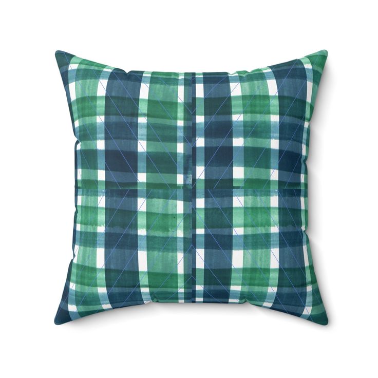 a blue and green plaid pillow on a white background