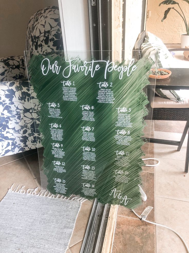 a green menu sign sitting on top of a glass window next to a chair and table