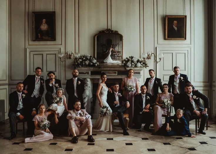 a large group of people posing for a wedding photo