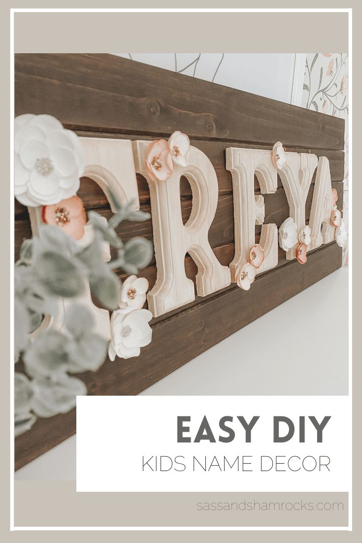 a wooden sign that says easy diy kids name decor with flowers on the letters