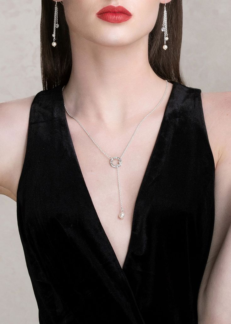 Get on trend with our IZZY lariat finest imitation pearl drop necklace. Made with the finest quality crystals and pearls, this modern piece of jewelry can be adjusted to any desired length and can be worn in the front or back. This necklace is available in bright silver or bold gold. Pair it with a deep plunging neckline, an open back top or gown. It truly is the perfect accessory to wear for any occasion. This simple yet elegant necklace is made with nickel-free metal and measures 24 inches lon Pearl Drop Necklace, Open Back Top, Elegant Necklace, Pull Through, Elegant Necklaces, Lariat Necklace, Luxury Accessories, Drop Necklace, Austrian Crystal