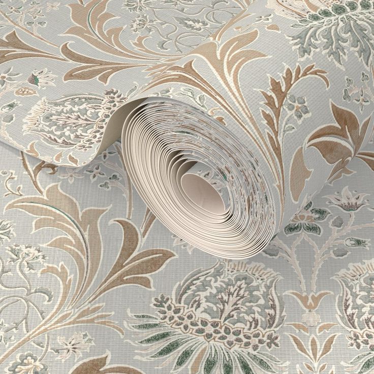 a roll of white and gold wallpaper with floral designs