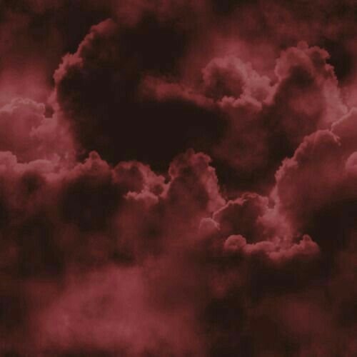 the sky is filled with clouds in red and black