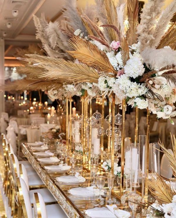 a long table with white and gold decorations