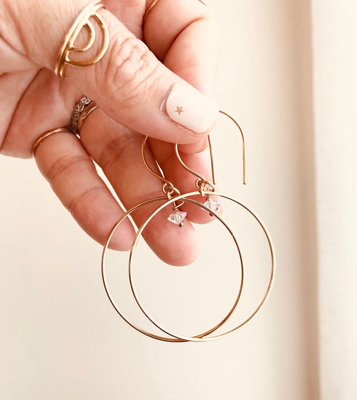 Just as effortless as they are simple, these hoop earrings are an essential everyday piece. Item Details: • This listing is for A PAIR ( 2 pieces ) earrings.• All metal is components are sterling silver and 14k gold-fill• Hoops measure 40mm in diameter.• Herkimer quartz crystals prized, each Herkimer diamond is a natural entity and no stone is identical.• The order will arrive in a gift-wrapped box and free polishing cloth. It will be ready for gift giving. All our work is custom-made by hand in Everyday Hoop Jewelry In Recycled Gold, Everyday Recycled Gold Hoop Jewelry, Everyday 14k Gold Filled Huggie Earrings, Nickel-free 14k Gold Hoop Jewelry, Tarnish Resistant Small Hoop Jewelry For Everyday, Tarnish-resistant Small Hoop Everyday Jewelry, Dainty Small Hoop Everyday Jewelry, Dainty Small Hoop Jewelry For Everyday, Gold Small Hoop Jewelry For Everyday