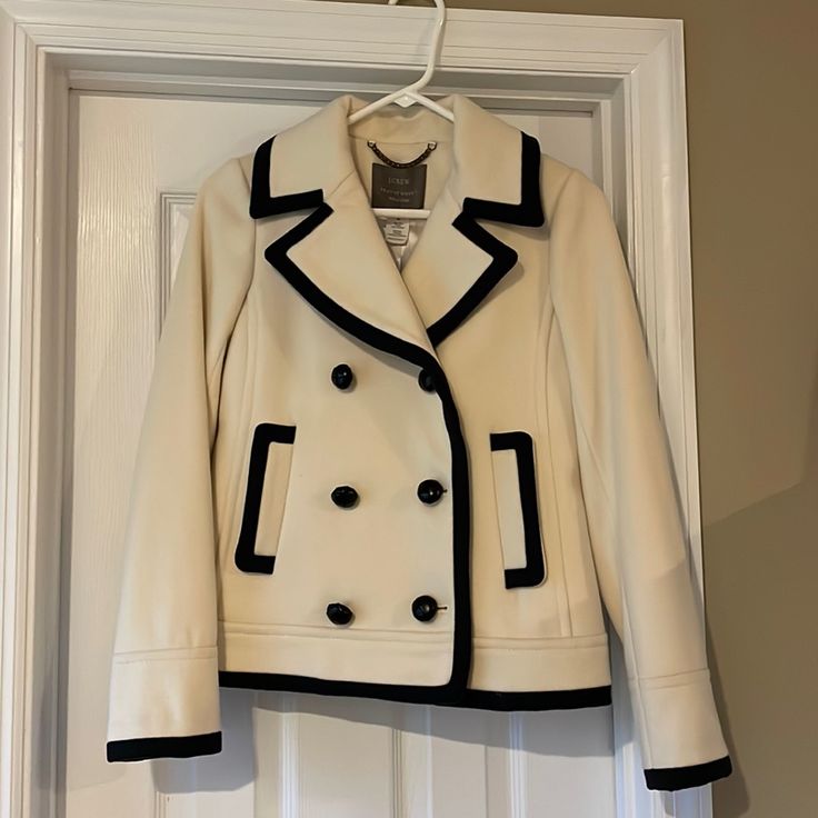 Nwt J. Crew Cream Navy Tipped Wool Nello Gori Peacoat, Size 00. Never Worn! Beautiful 100% Wool Peacoat With Polyester Lining. Cream With Dark Navy (Could Pass For Black) Piping. Measures 24” From Collar To Hem, 14” Across Shoulders. Comes From A Smoke Free Home. Cream Double-breasted Pea Coat For Work, Winter White Pea Coat For Spring Workwear, Cream Pea Coat For Office, Classic Spring Outerwear With Contrast Trim, Classic Tailored Outerwear With Contrast Trim, Winter White Pea Coat For Work, Chic White Pea Coat For Workwear, White Pea Coat For Workwear In Fall, Tailored Outerwear With Contrast Trim For Fall