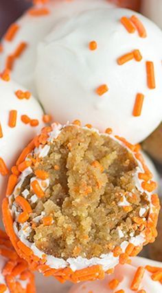 carrot cake balls with white frosting and orange sprinkles on the top