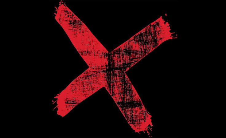 the letter k is painted red and black with paint splattered on it's surface