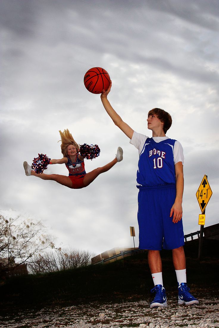 two people are playing basketball in the air