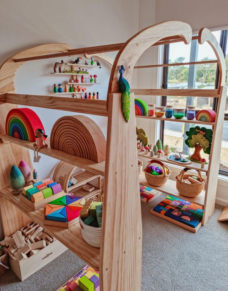 a child's play room with wooden toys and rainbows on the shelves,