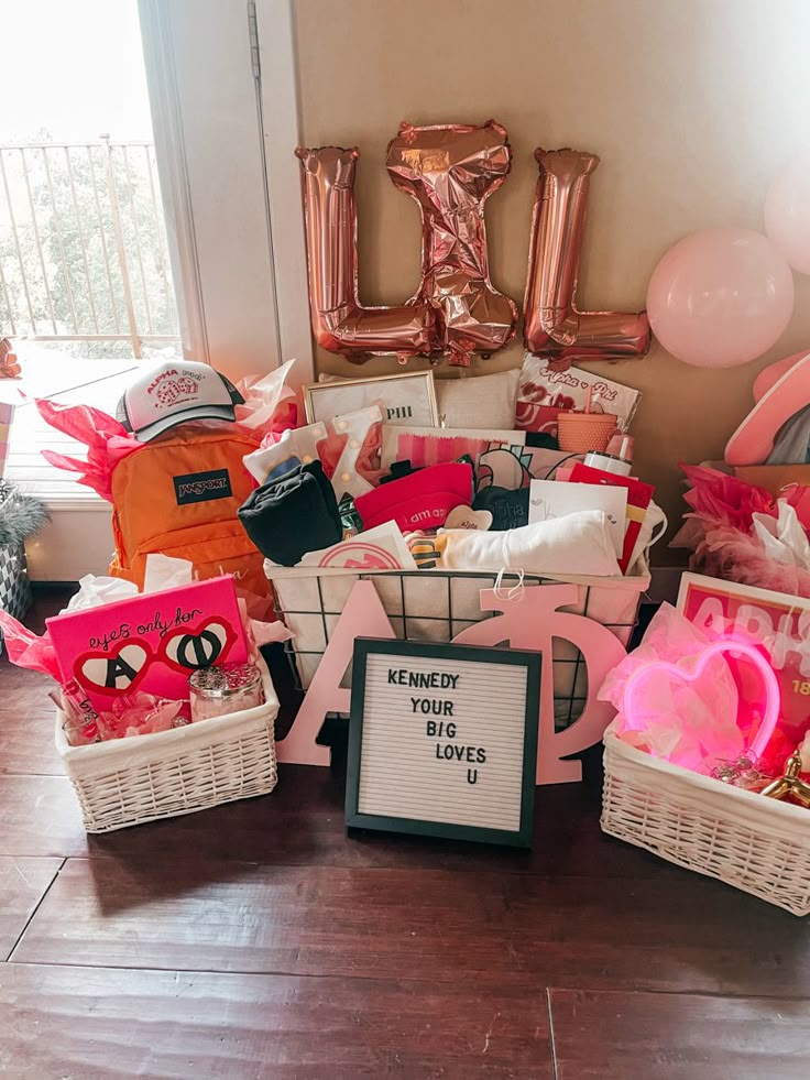 a basket filled with lots of pink and white items sitting on top of a wooden floor