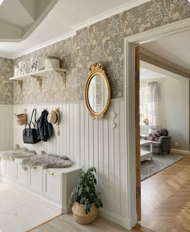 there is a white sink and mirror in this room with wallpaper on the walls