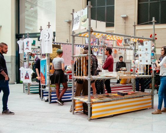 people are standing around at an art fair