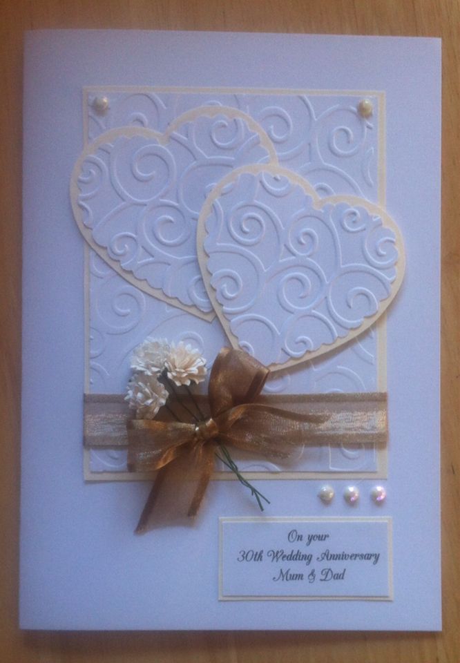 a wedding anniversary card with two hearts on the front and one heart in the back