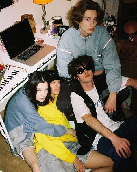 three people sitting in front of a laptop computer