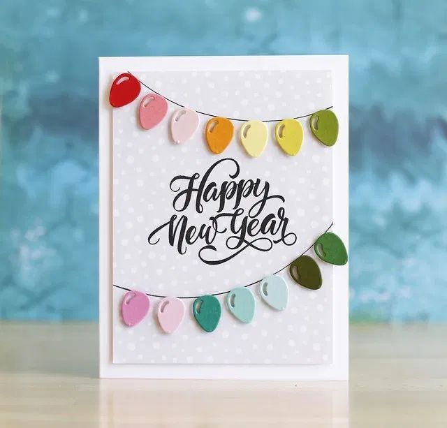 a happy new year card with colorful paper hearts