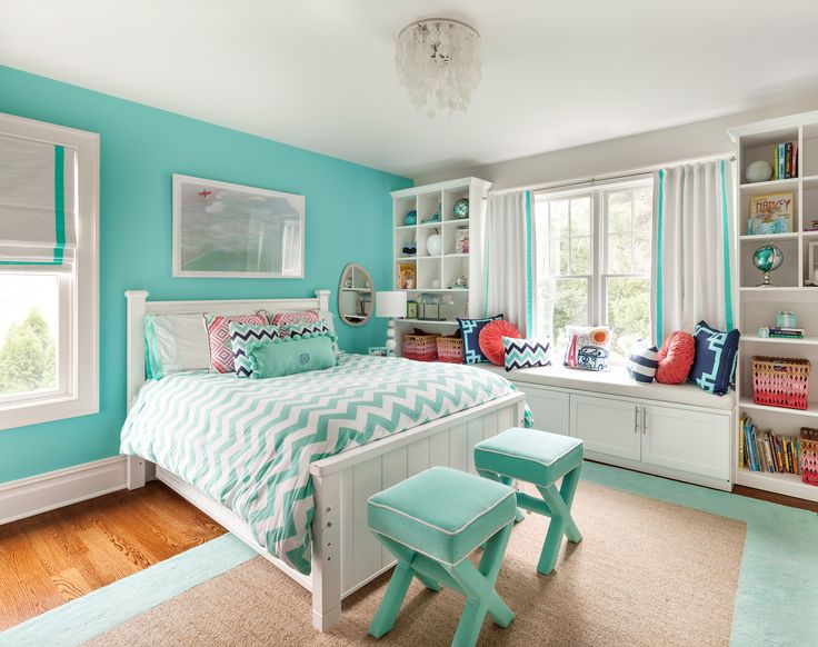 a bedroom with blue walls and white furniture